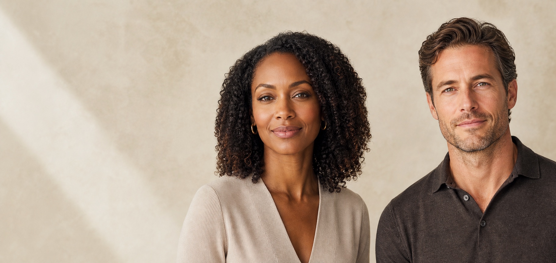 A Black woman and a white man with natural, confident expressions